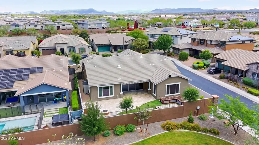 This energy-efficient Phoenix home showcases solar panels and backs to a lush community greenbelt. Enjoy peaceful views, desert landscape design, and prime positioning in the desirable Desert Ridge neighborhood.