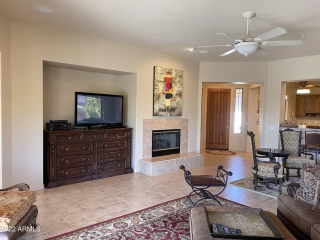 Perfectly sized family room with gas fireplace and flat screen TV. Sliding door to south facing covered patio with water feature.
