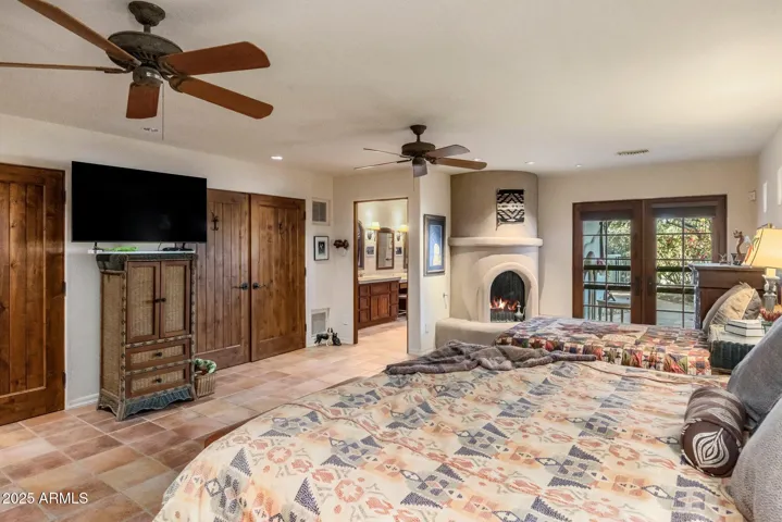 Third Primary Bedroom with Kiva fireplace offers warmth and ambiance for cozy evenings
