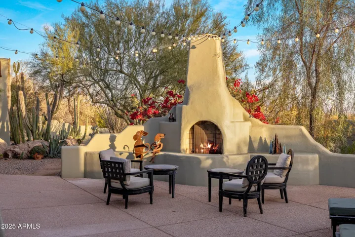 Gas Kiva fireplace in the backyard with bistro lighting