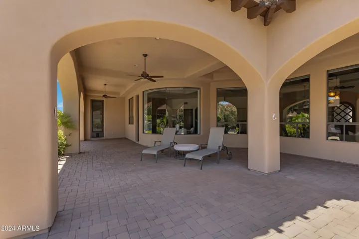 Expansive concrete paver patios extend more than 20 feet and are the full length of the home.