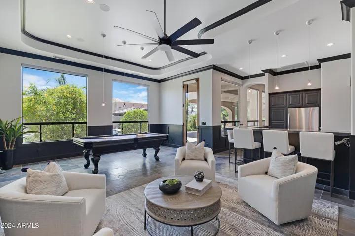 Game room with wet bar, ice maker and full sized fridge.