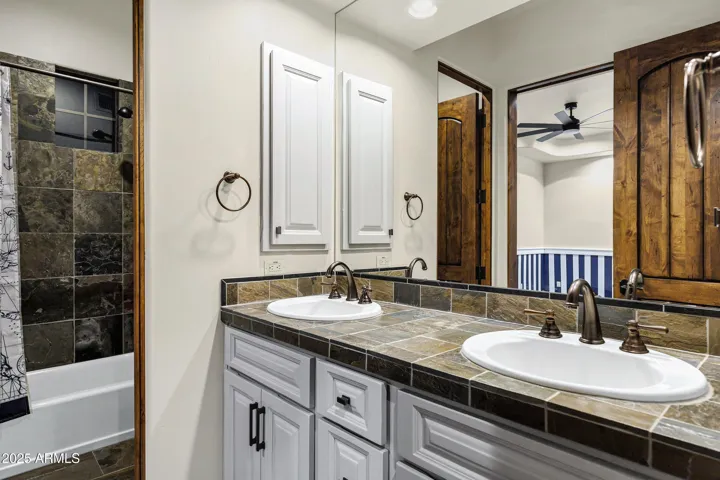 Jack & Jill bath offers double sinks with separate tub and shower area