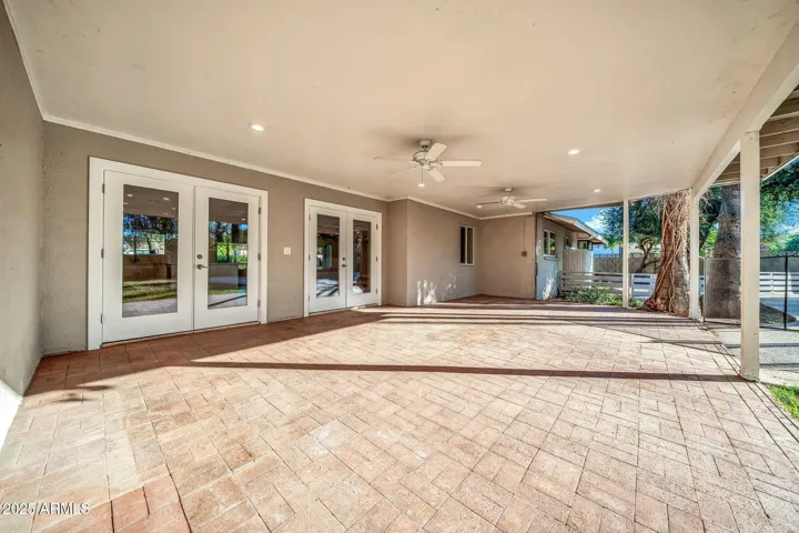 Two sets of double doors open up to the covered rear patio