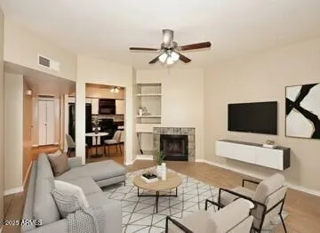 Open floorplan with cozy fireplace, tall ceilings, & beautiful wood-look tile flooring T/O!