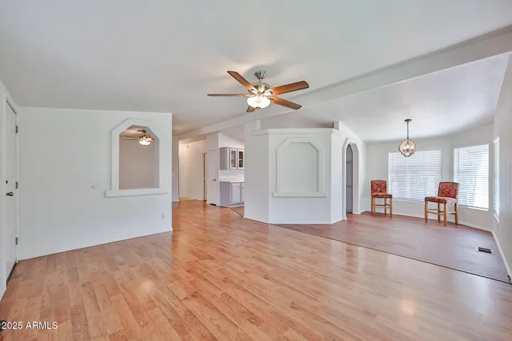 Large front room looking into kitchen table area and 2nd living room behind arch