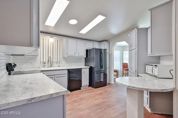Kitchen has solatube for light plus ceiling lights.