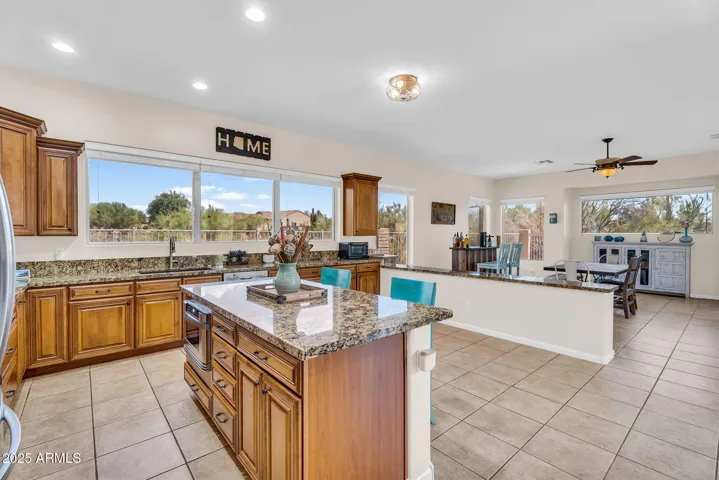 Kitchen opens to second living room for huge open space