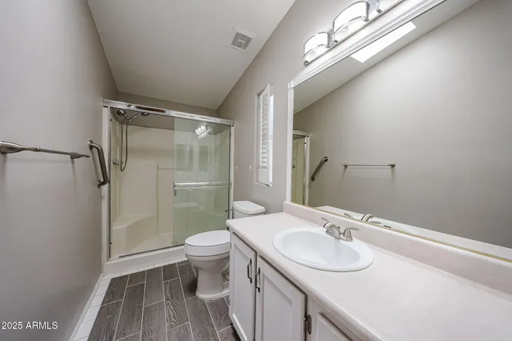 Master bath has newer flooring and glass shower doors