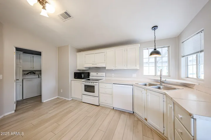 Kitchen opens to laundry room