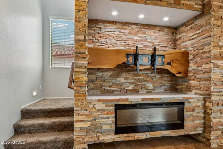 fireplace and stonework featured in the living area