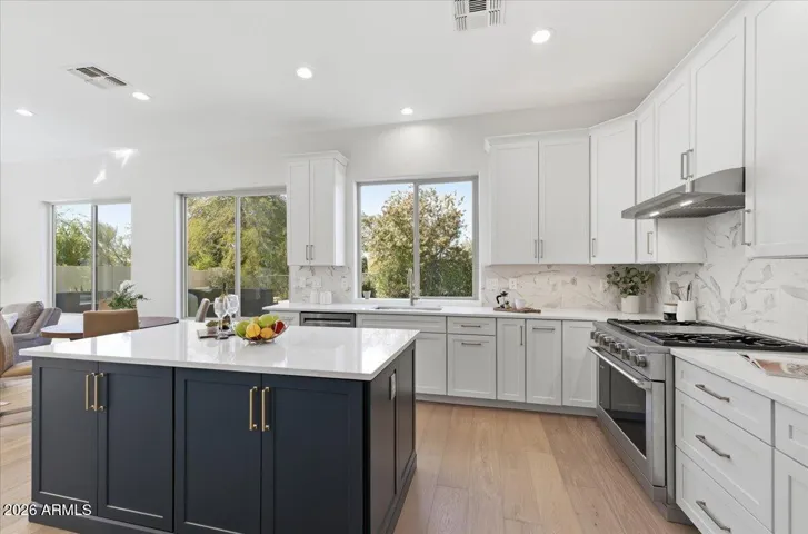 An abundance of storage defines the new kitchen, highlighted by 48"-tall upper cabinets and a dramatic 80" wall of floor-to-ceiling cabinetry.
