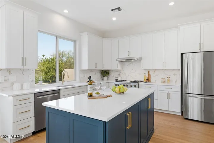 An abundance of storage defines the new kitchen, highlighted by 48"-tall upper cabinets and a dramatic 80" wall of floor-to-ceiling cabinetry.