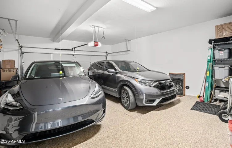 Oversized garage has large storage space in front of parking, epoxy flooring, too.