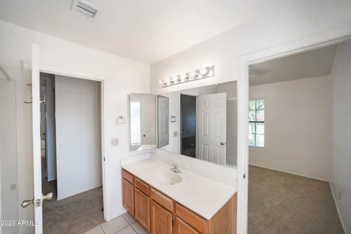 This is a full bathroom with doors to the hallway and the 3rd bedroom.