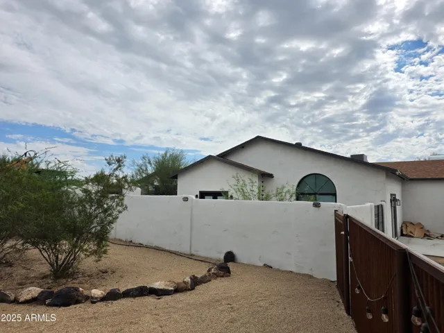 Front of property boasts designated RV Parking with RV access available to the rear 1+ Acre fully fenced rear yard.