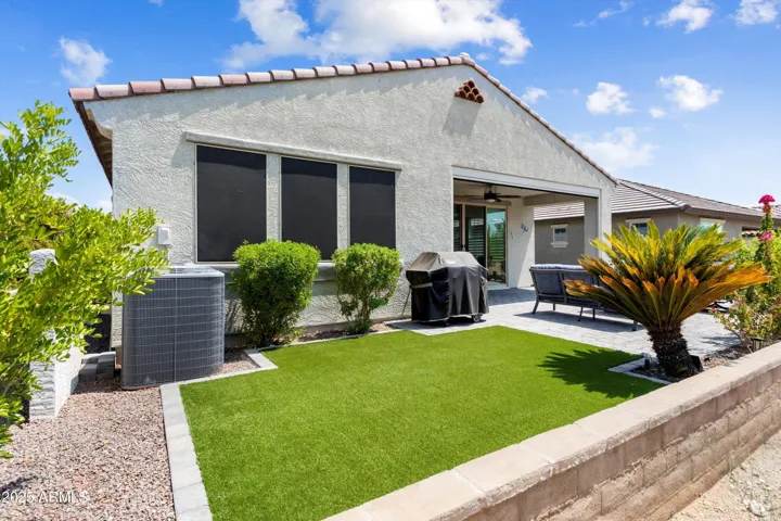 Beautifully landscaped with pavers and synthetic grass