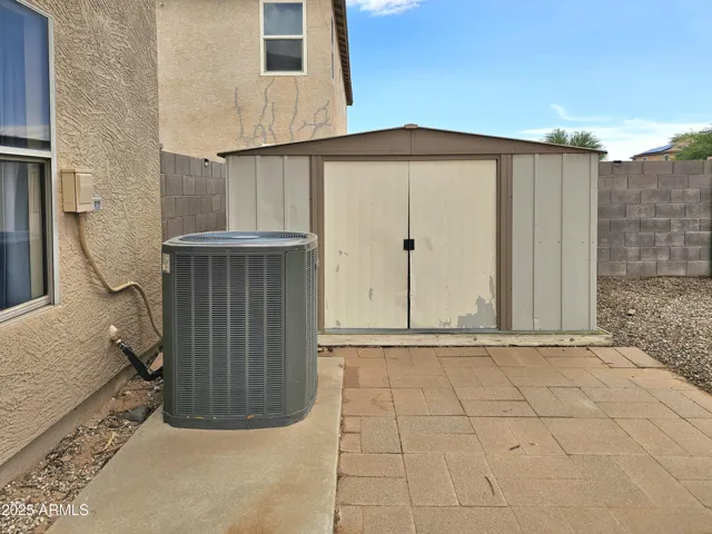 Storage shed with pool tools included.