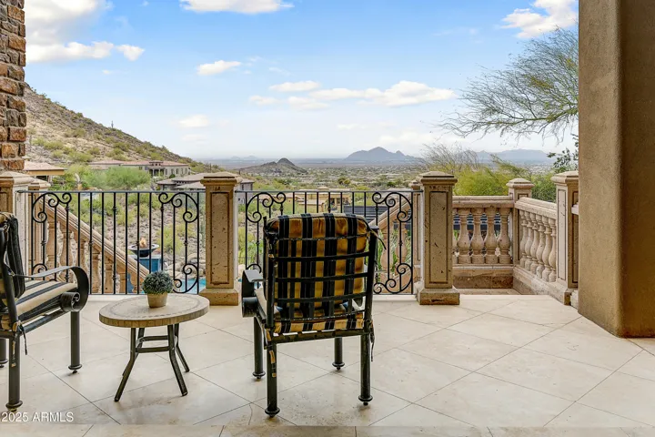 The perfect blend of tranquility and luxury, this private balcony boasts resort-style vistas, a fireplace, and a full view of the negative-edge pool and spa below. A prime example of elevated outdoor living in a premier Scottsdale location.