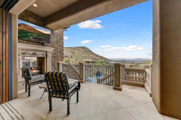This serene private balcony features a cozy two-way fireplace shared with the primary suite and beautiful tile flooring. Enjoy peaceful mornings and dramatic Arizona sunsets while overlooking the infinity pool and distant Camelback Mountain views.