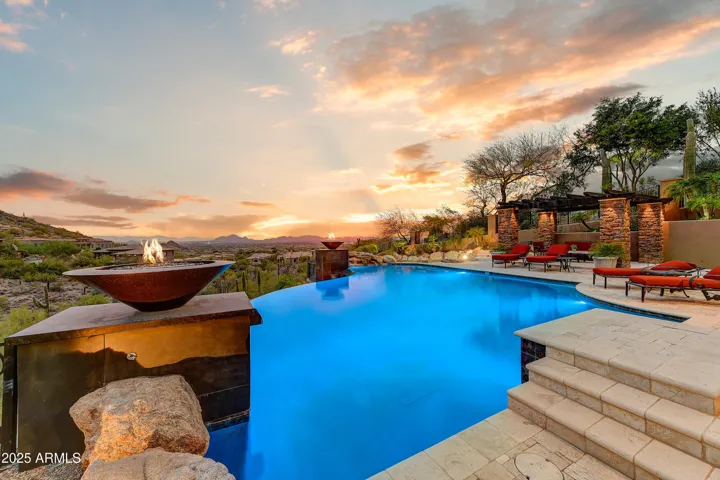 This elevated outdoor space captures the beauty of dusk with dramatic skies and unobstructed views. Enjoy serene moments around the pool or fire features as day transitions into night over the Sonoran Desert.