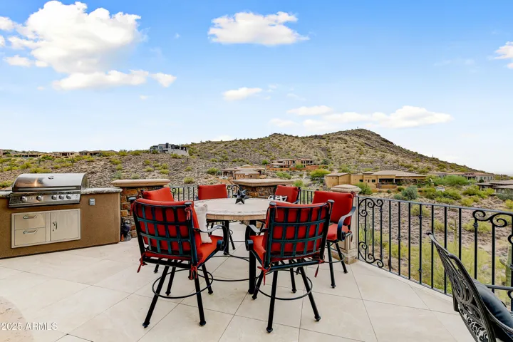 Entertain alfresco with this built-in outdoor kitchen and dining area. Surrounded by natural beauty and mountain terrain, it’s the ultimate Scottsdale outdoor living setup.