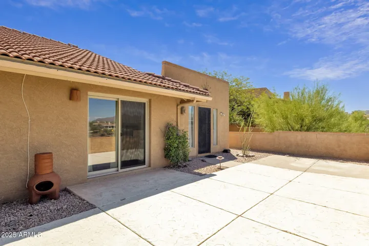 Charming home featuring a spacious patio and expansive yard, perfect for outdoor gatherings and relaxation.