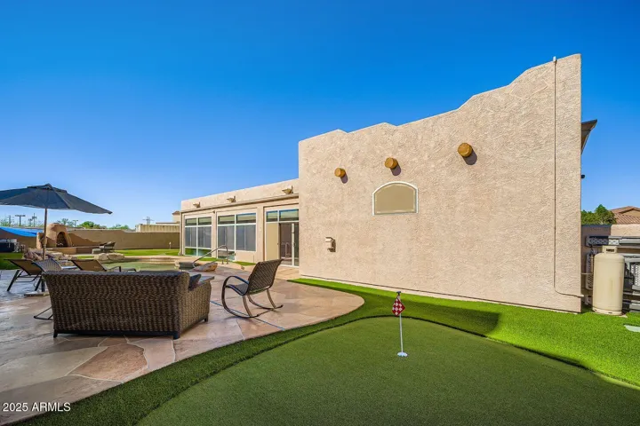 Heated pool, stamped concrete and putting green