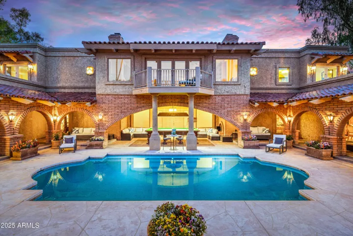 View upon arrival entering from the carport through the giant French doors opening to the massive courtyard with the perfectly private walk-in Roman pool, snooker lounge and plenty of outdoor seating.