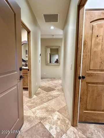 Travertine everywhere and Custom wood Alder doors throughout.