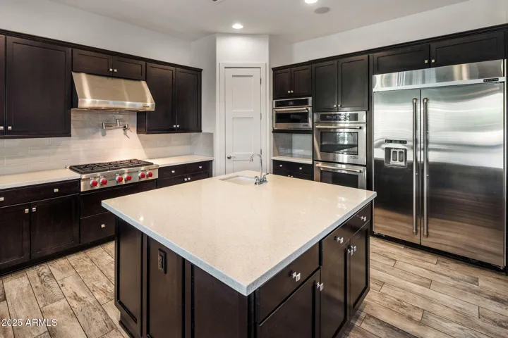Chef's kitchen with high end appliances, RH lighting, breakfast nook.