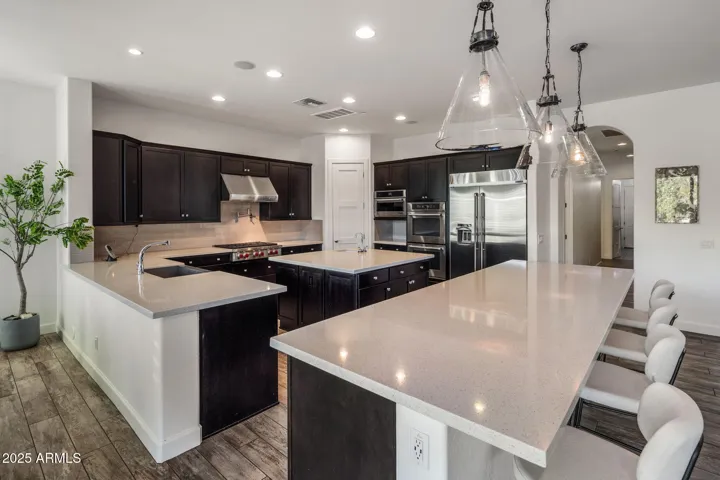 Chef's kitchen with high end appliances, RH lighting, breakfast nook.