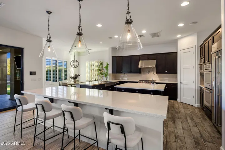 Chef's kitchen with high end appliances, RH lighting, breakfast nook.