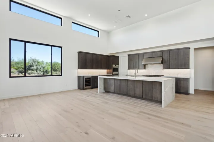 Kitchen with waterfall edge quartz countertops and backsplash