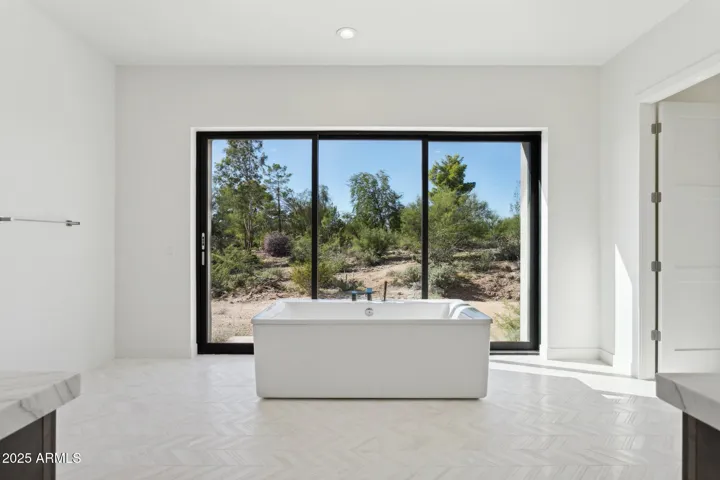 Primary Bathroom with luxurious stand-alone tub and large sliding glass door