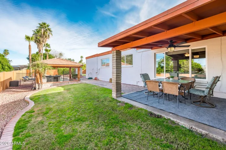 Covered patio for dining and grass area for play and pets.