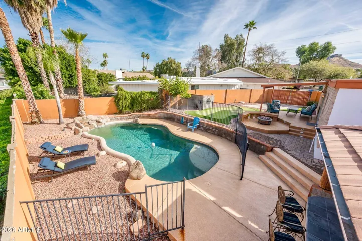 Pool, waterfall, ramada with BBQ, putting green, covered deck & patio, RV gate & grass yard.