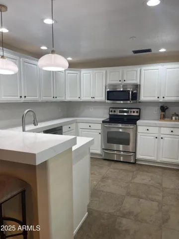 KITCHEN HAS QUARTZ COUNTERS AND BACKSPLASH