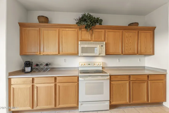 Beautiful kitchen with plenty of counter space and wood cabinetry, providing practicality and style for daily living in this Surprise home.