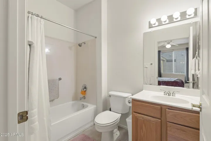 Clean and well-maintained guest bathroom featuring a full tub/shower combination, modern lighting, and ample storage for everyday comfort.