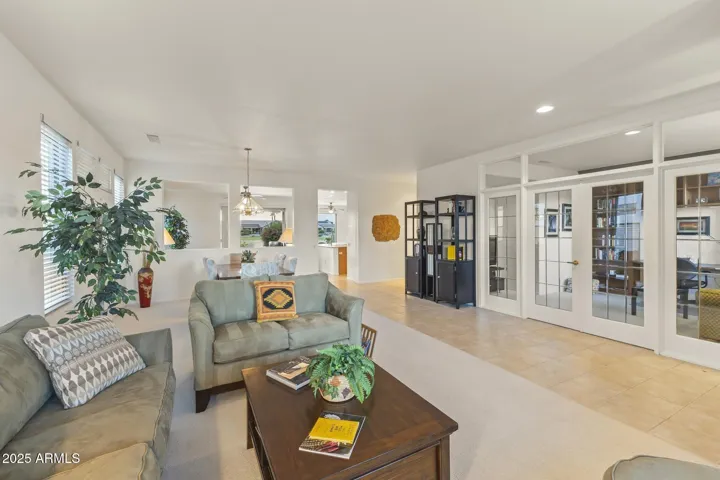 Formal dining room with contemporary lighting, stylish furnishings, and open layout—ideal for hosting gatherings or intimate dinners.