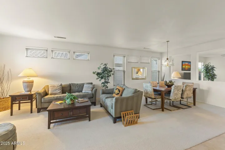 Light-filled living and dining space with soft neutral tones, large windows, and designer lighting—perfect for entertaining in comfort.