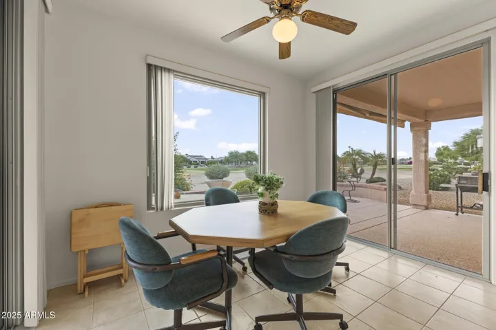 Bright and airy nook space featuring wraparound windows, sliding doors, and serene golf course views—a perfect place to start or end your day.