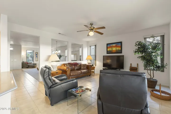 Light-filled family space with modern ceiling fan, comfortable seating, and open sightlines—designed for connection and easy living.