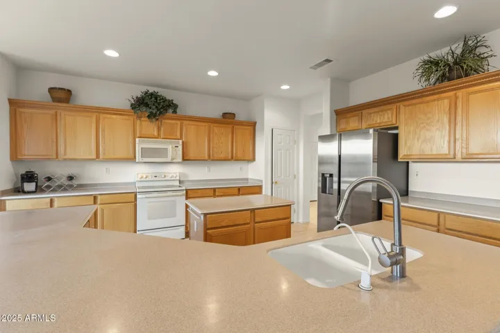 Well-appointed kitchen with extensive cabinetry, solid-surface counters, and sleek appliances—perfect for hosting and family meals.