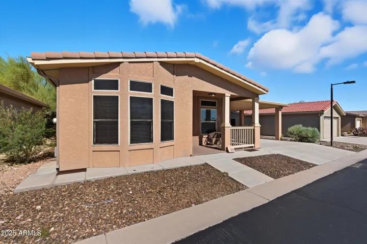 Charming front entry with covered patio area, perfect for relaxing and taking in the peaceful desert setting