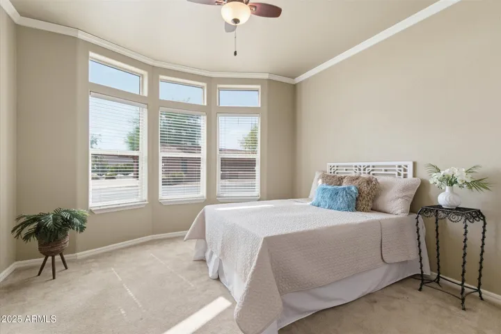 Guest suite includes carpeted flooring, ceiling fan, large bay windows with blinds and Crown Molding,