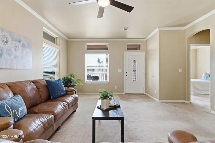 Spacious living area with tile flooring, large windows, and views that showcase the bright and airy feel of the home.