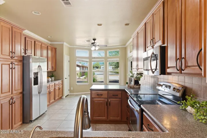 Includes Quartz counter tops, numerous cabinets with handles including built-in pantry, matching Stainless Steel appliances (including glass top stove and French door refrigerator), recessed ceiling lighting and look at the Quartz counter top space!!