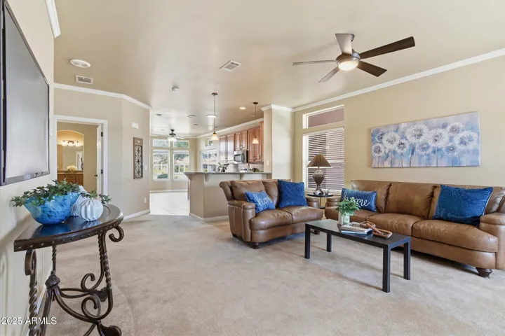 Carpeted flooring, ceiling fan, 2-tone neutral paint, Crown Molding and blinds on all windows.